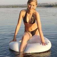 Cute teen plays outside on the lake on her tube then gets naked