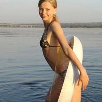 Cute teen on her tube on the lake having fun in a bikini