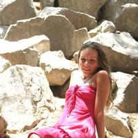 Sexy teen sits out on some rocks in the shadows in her pink prom like dress so sexy