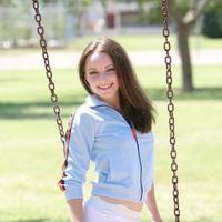 Tabitha shows a little bit of cleavage as she swings outside in her blue outfit