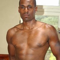 Shaved ebony bodybuilder posing naked