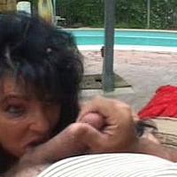 Dirty big-haired granny licking large meaty cock by the pool
