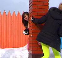 Two teenagers throwing snow balls