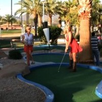 Naughty busty babes, Angie Savage and Rachel Aziani, go miniature golfing and they both have fun flashing their big titties arou