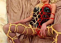 Colorful ropes and sexy fetish lingerie make this blonde look delicious and seductive