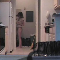 4 nice hidden cam vids of a lovely wife in a kitchen wearing panties and a T-Shirt.