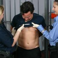 A bad prisoner getting strip searched by hotties