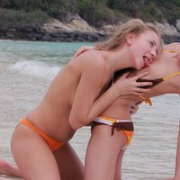 Two cute blonde teens tonguing pussy on the beach