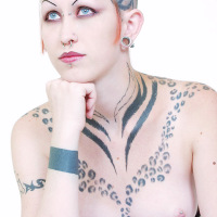 Tattooed corseted Punk rocker with glass sex toy