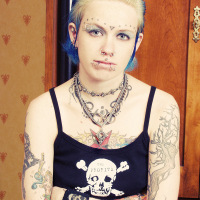 Sexy tattoo punk girl strips off skull gear