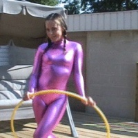 Taylor using a hooahoop in her tight pink shiny outfit