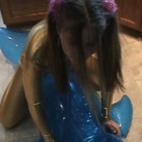 Sexy gold outfit and riding a blowup dolphin