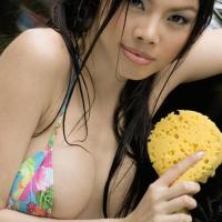Seductive Asian Asia washing her round breasts on a car