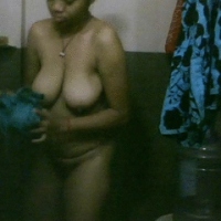 Indian beauty pressing her boobs in shower.