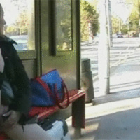 Horny woman masturbates in a bus stop