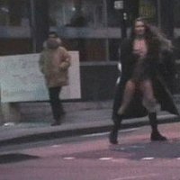 Crazy girl gets totally naked in the middle of a super crowded street