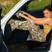 Topless brunette military teen in a car