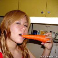Asian teen puts a cucumber in pussy