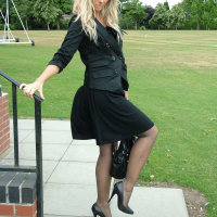 Beautiful blonde dressed in black and showing off her high heels