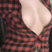 Alluring Vixen Laurens big breasts are barely covered by her open plaid shirt