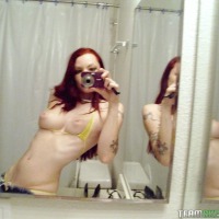 Sexy redhead emo goth takes cute pics of herself and then toys with her shaved wet teen pussy on camera