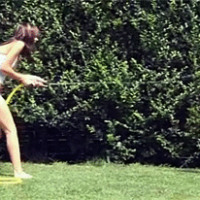 Two cute lesbian chicks playing with a water hose