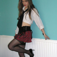 Horny crossdressing tart Kirsty in a saucy schoolgirl outfit