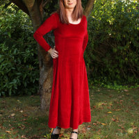 Lucimay posing outdoors in a gorgeous long red dress