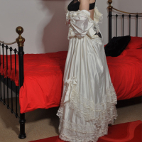 Sexy crossdresser wearing a long wedding dress and horny satin gloves.