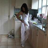Alison's very feminine and stylish high heel are accentuated by her being all in white. Sensing your presence she lifts the hem 