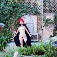 Magical pale redhead naked Cosplay in the garden