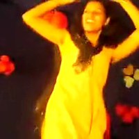 Pretty Indian babe on the stage dancing on her favorite tune watch her as she moves her body shake.