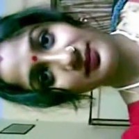 Watch this sexy Indian babe getting undress with her red saree showing her top and stomach.