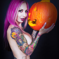 Pink haired big tittie tattoo pin-up babe pumpkin carving Halloween