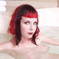 redhaired punk chick naked and spread in bathtub