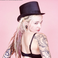 dreadlocked tattooed goth blonde in top hat heels