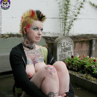 Hot tattooed punk babe by gravestone